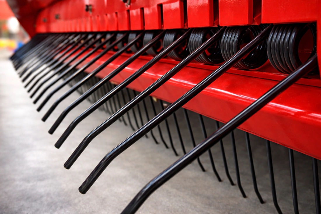 Close-up of the jam-free wide pickup system on the round baler