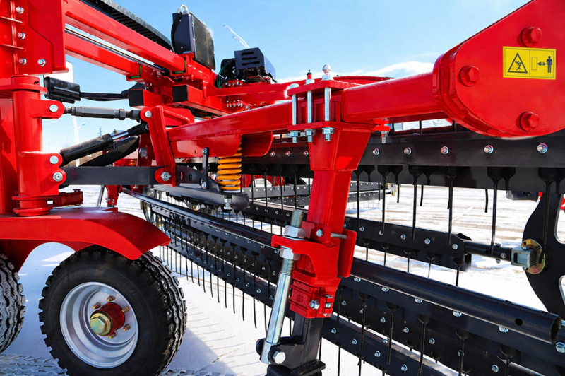 Front-mounted roller rake operating gently on alfalfa fields to retain leaves