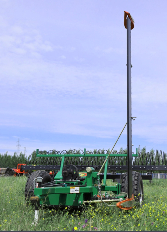 Close up view of the mower deck and trailing rake tines in action